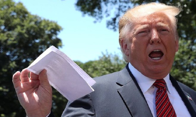 Trump reveals Mexico migrant plan by waving document around