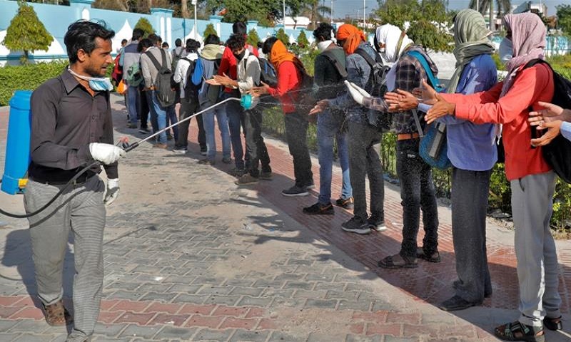 Covid-19: Anger as migrant workers sprayed with disinfectant in India