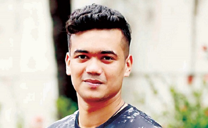 Cricketer Taskin Ahmed stands beside people 