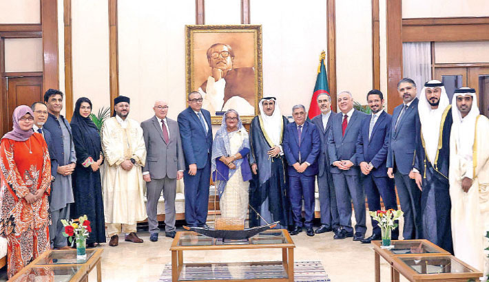 Envoys of various countries, including Saudi Arabia, the United Arab Emirates, Kuwait, Qatar, Libya, Malaysia, Brunei Darussalam, Egypt, Iran, Oman and Palestine, pose for a photograph with Prime Minister Sheikh Hasina at her official Ganabhaban residence in the capital on Tuesday, marking her party Awami League's absolute victory in the 12th parliamentary election. -PID PHOTO