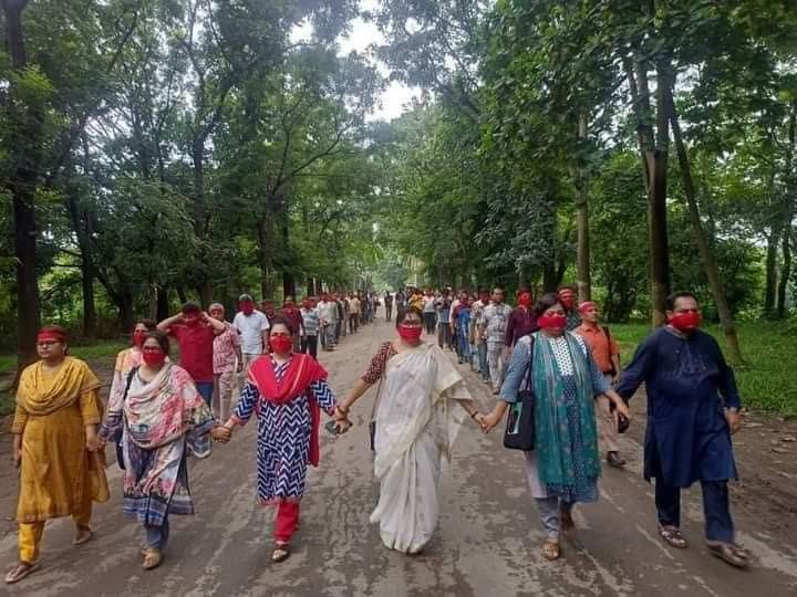JU teachers, students hold silent march wearing red masks