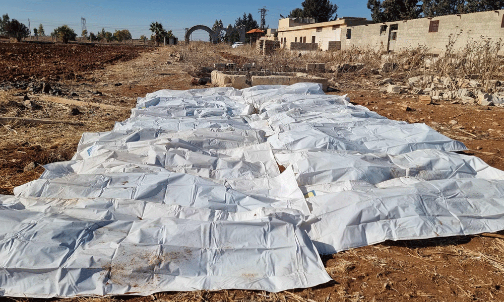 At least 100,000 bodies in mass grave near Damascus