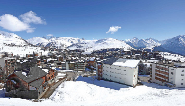 This aerial photograph shows a partial view of the L'Alpe d'Huez ski resort, in the French Alps, on 17 March 2025. Photo: AFP