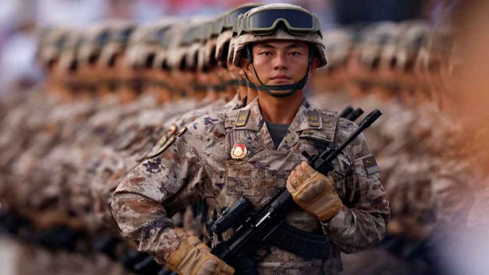 Japan rejects 'new militarism', accuses China of rapidly arming