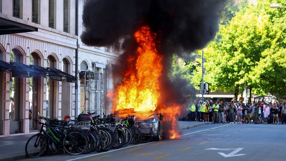 Protesters set Tesla ablaze, smash UN office's windows in Geneva anti-G7 march