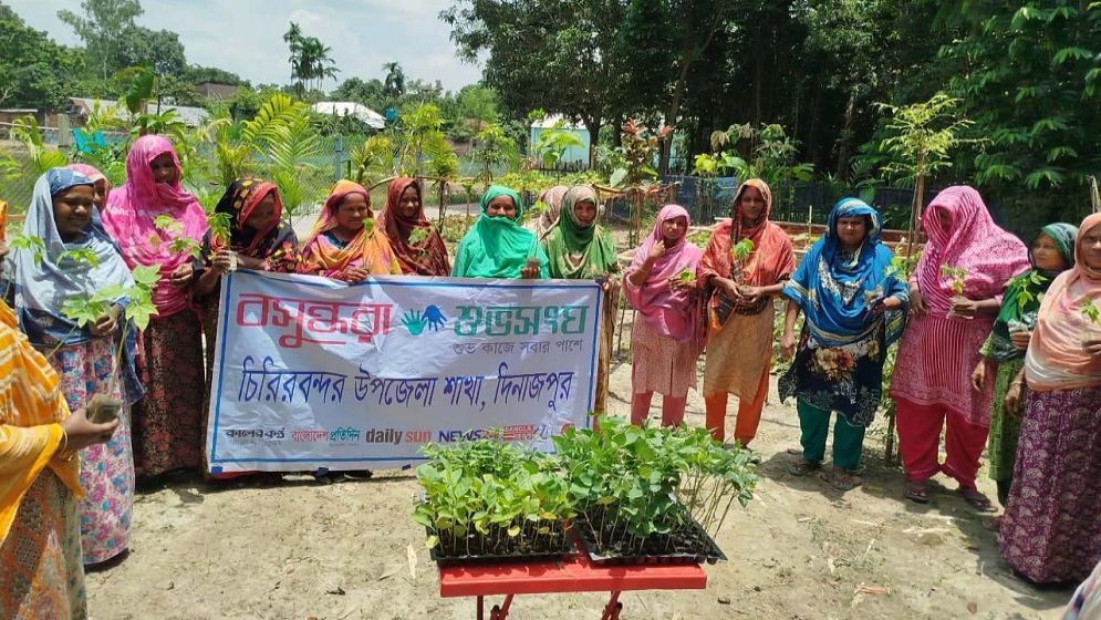 Women get vegetable seedlings at village in Dinajpur