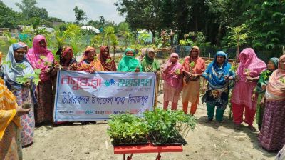 Women get vegetable seedlings at village in Dinajpur
