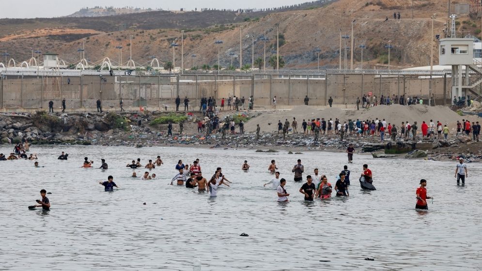 Spain says huge surge across border into enclave has reversed, half of migrants go back
