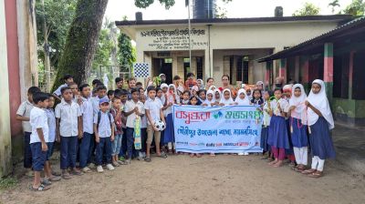 Children get sports equipment at school in Mymensingh