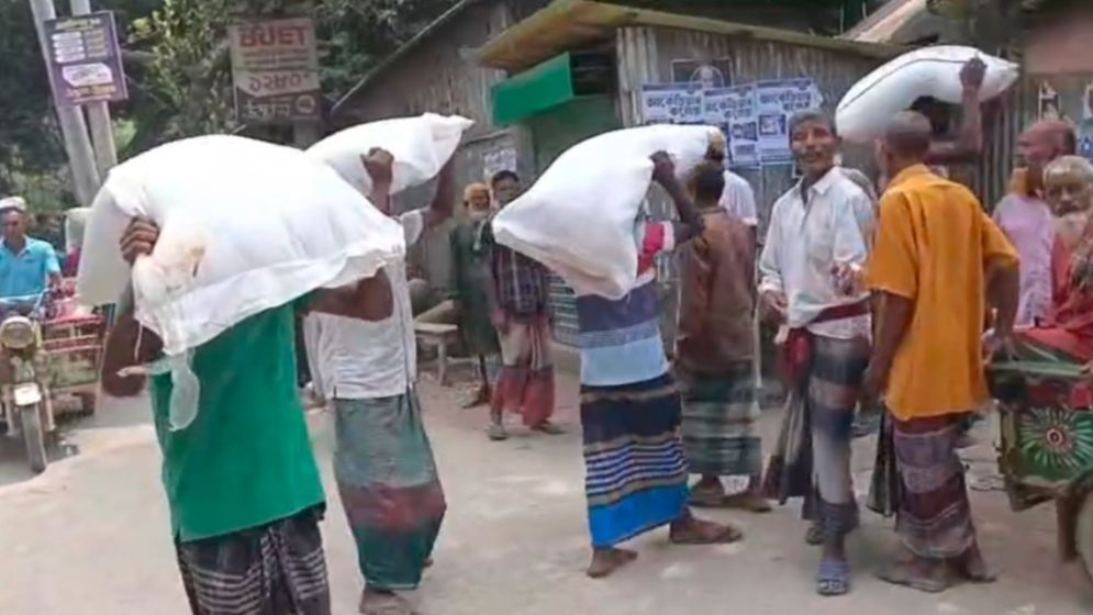 Farmers take away fertiliser sacks from depot in Kurigram