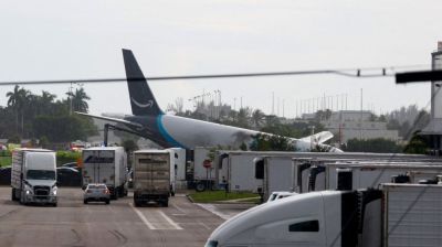 Amazon cargo plane overshoots Miami runway, hits vehicles, catches fire