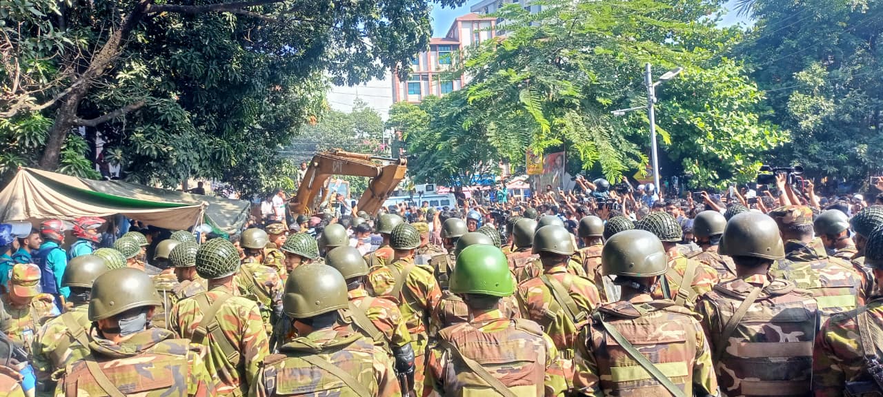 Police confront protesters outside Hasina family home